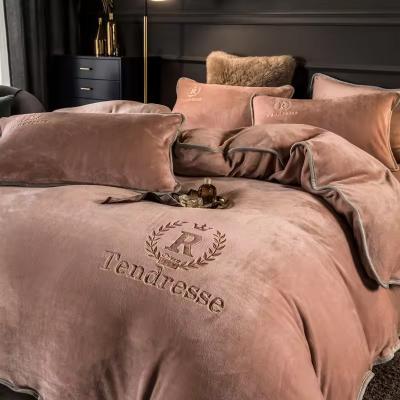 China Customized Solid Milk Velvet Embroidery Bedding Set Thickened Warm Flannel Four Piece Set for sale