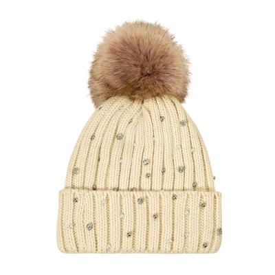 China COMMON knit inlaid hat with rhinestones fashion fur ball decoration warm ear protection hat for sale