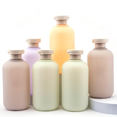 China Cosmetic Environmental Pink Green PE Plastic Shampoo Bottle With Flip Cap Fancy News Body Wash Bottles With Screw Cap for sale