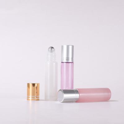 China Gold Cosmetic Cap Steel Ball Cylinder Ball Cylinder Ball Bottle Essential Oil Perfume Glass Round Bottle With Lid for sale