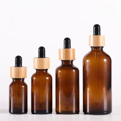 China 5ml 10ml 30ml 1oz Cosmetic Cosmetic Amber Glass Bottle With 50ml 100ml Dropper Bamboo Clear Brown Glass Oil Bottles for sale