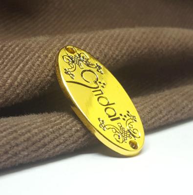 China Custom Stamping Gold Plate Clothing Sustainable Metal Label Engraved Label Sewing Waterproof Hijab Metal Logo For Clothing for sale