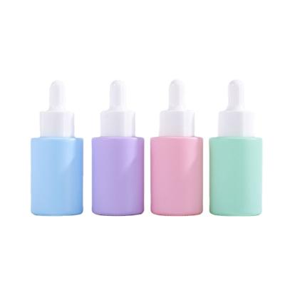 China Custom dragon cosmetic glass color mark bottle 30ml shoulder flat cylinder glass bottle for essential oil for sale