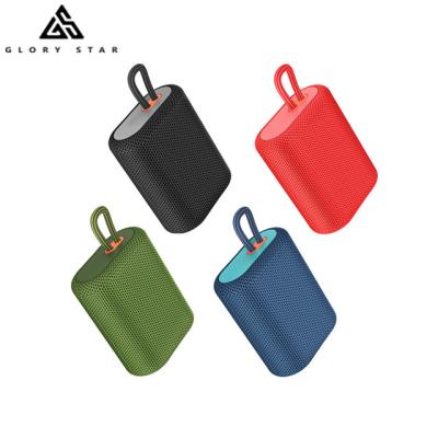 China Wireless Portable BT Speaker With Lanyard Fabric Wrap Candy Color Speaker for sale