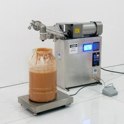 China Máquina de llenado de líquido de acero inoxidable Máquina de llenado de aceite automática pequeña en venta