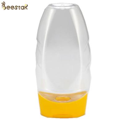 China Precio de fábrica plástico de la categoría alimenticia Honey Jar And Spoon plástico especial 335ml vacío en venta