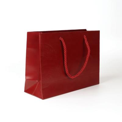 China Recycled good quality handbag materials eco red shopping bag to friend customized luxury gift paper bags with handle and ribbon bow tie for sale