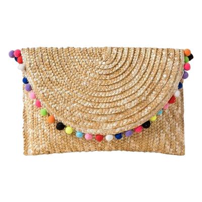 China Clutch Pom Poms Wheat Straw Clutch Bag for sale