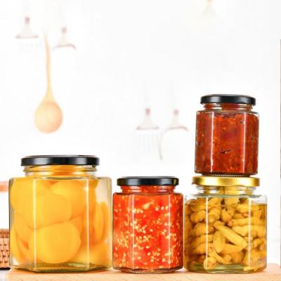 China Food Wholesale Empty Airtight Glass Storage Jam Jar Mini Hexagonal Glass Honey Jars With Dispenser Lid for sale