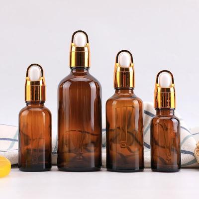 China Cosmetic Factory Direct Sales dropper fine oil bottle 10ml 20ml 30ml 50ml 100ml amber empty glass bottles with aluminium gold cap for sale