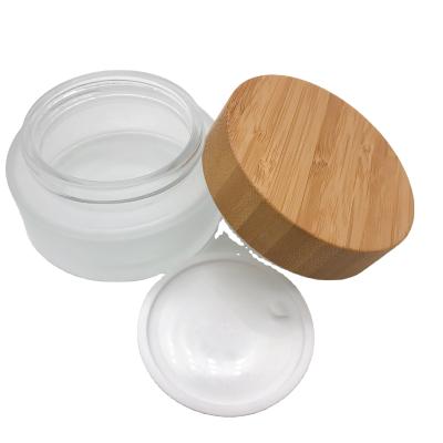 China Personal Care Customized 5G 20G 30G 50G 100ml 200Ml Thick Bottom Cosmetic Wooden Bamboo Wooden Small Lids Cap Cosmetic Frosted Glass Clear Jars for sale