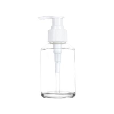 China Manufacturers 120/200ML Boston Round Glass Cosmetic Clear Pump Bottle For Shampoo Hand Sanitizer for sale