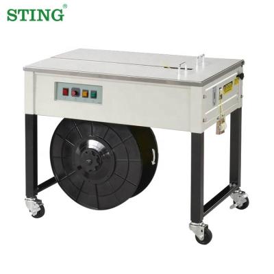 China Semi-automatic CLOTHING Table PP Low Binding Strip Carton Box Tying Packing Machine for sale