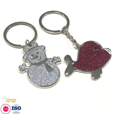 Cina Newest Custom Manufacturer Snowman Cute Gift Key Ring Silver Plated Charm Dolphin Animal Keychain with Glitter in vendita