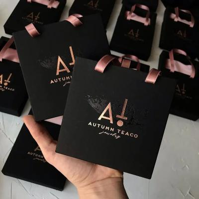 China Hot Stamping Custom Gold Small Gift Paper Bag Luxury Cardboard Wedding Black Paper Bags Recyclable Rigid Exquisite Packaging Bag for sale