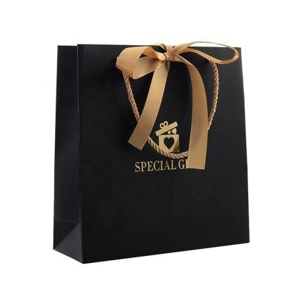 China Recycled Materials Custom Design Logo Grocery Packaging Craft Paper Wholesale Gift Bags Shopping Bags With Handle for sale