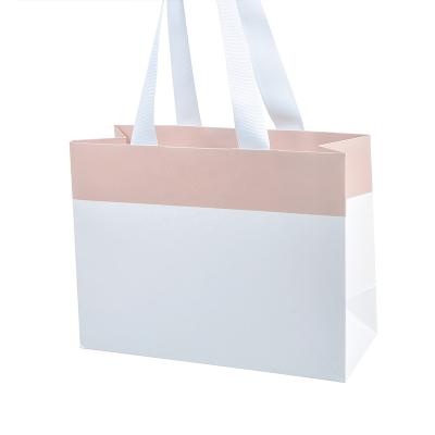 China Wholesale Custom Recyclable Luxury White Clothing Paperboard Recyclable Logo Gift Paper Bags Large Shopping Bag Recyclable Paper Bag With Handles for sale