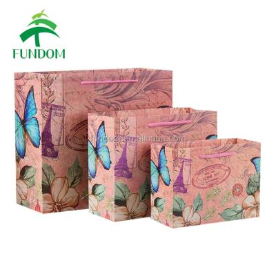 China Wholesale Good Quality Stock Pink Butterfly Design CMYK Recyclable Offset Paper Printing Bag for sale