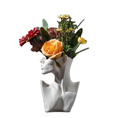 China Modern creative ceramic main flower arrangement in flower vase body face planter flowerpot room decoration for sale