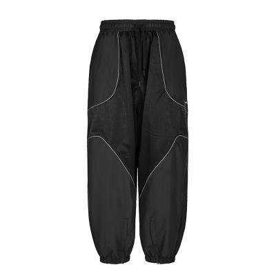 China Pantalones de esquí unisex con líneas reflectantes y pegamento a prueba de viento en venta