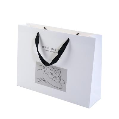 China Recyclable Custom Logo Card Panel Art Paper Bag Luxury White Ivory Cardboard Paper Gift Bag With Handles for sale