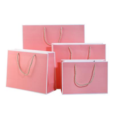 China Recyclable Wholesale Custom Printed Black Luxury Shopping Paper Gift Bag With Handle for sale