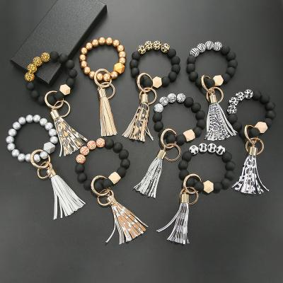 China Newest Wholesale Silicone Wooden Beads Lock Chain Bracelet For Women Big Circle Keychain Bracelet Stores PU Tassel Bracelet for sale