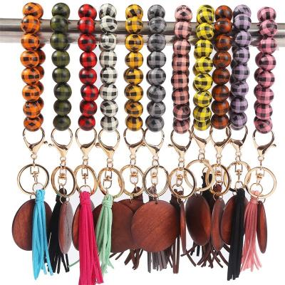 China 2022 Wholesale Custom Wooden Leopard With Beads Tassel Convenience Bracelet Bangle Key Chain Bracelet Wooden Key Chain for sale