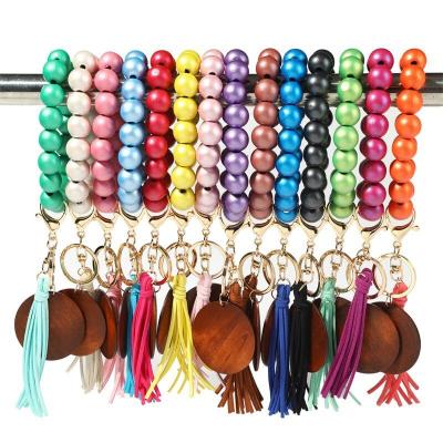 China Various Series Streched Series Beads Elastic Suede Disc Key Chain Elastic Bangle Bracelet Wooden Keychains Decorated with Wooden Tassel Wooden Monogram for sale