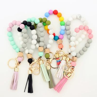 China Newest Rainbow Silicone Leather Strap Key Chain Tassel Leather Key Chain Tassel Can Add Wooden Chip Pendant Diy Monogram Keychain Bracelet for sale