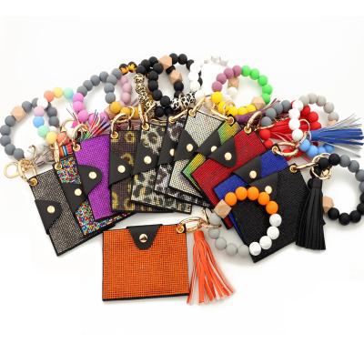 China Women PU Diamond Card Holder Coin Key Chains Colorful Rhinestones Silicone Tassels Pearl Anti-theft Leather Bracelet Wallet Pinch Key Chain for sale