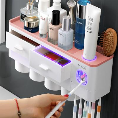 China Sustainable Luxury Plastic Bathroom Accessory Set Automatic Toothpaste Squeezer Dispenser Holder With Toothbrush Holder for sale