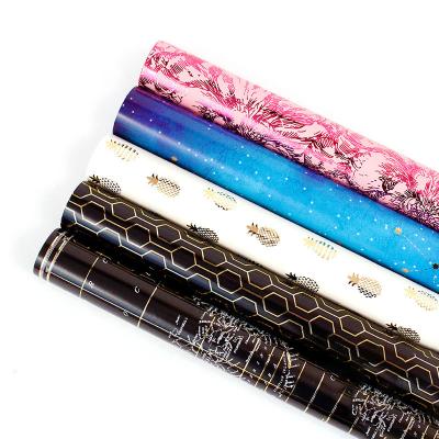 China Custom Recyclable Gift Wrapping Paper 105g Copperplate Printing Bronzing Waterproof Flower Gift Wrapping Paper for sale