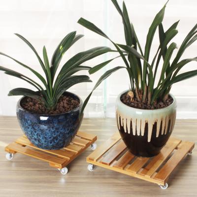 China Modern Most Popular Universal Wheel Flower Stand Movable Flower Pot Tray Movable Bamboo Flower Stand for sale