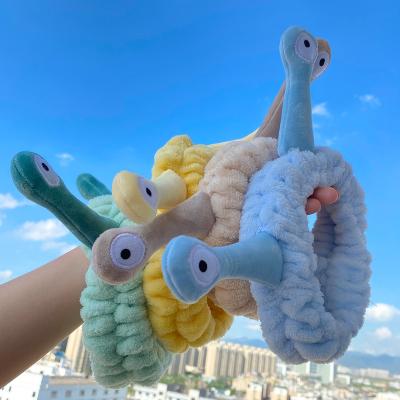 China Soft cute face eye hair decoration KISSWIFE women makeup frog flannel snail wash fluffy headbands for girls for sale