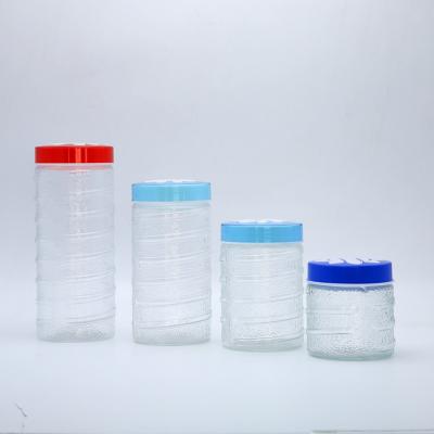 China 4 Piece Sustainable Vintage Clear Glass Storage Jars With Screw Lid Colored Plastic Glass Food Storage Jars for sale