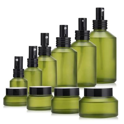 China Hot sale wholesale 1oz 2oz 4oz olive green glass bottle and jar for cosmetic packaging for sale