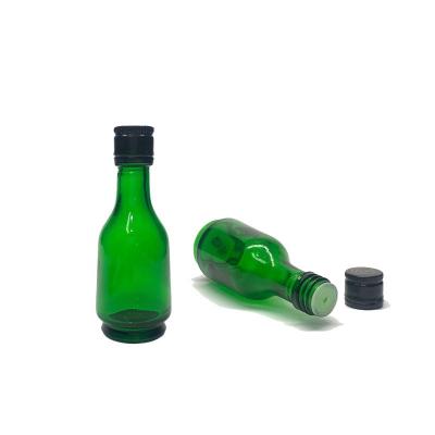 China Hot green decanter gold black glass bottle with rotating lid essential oil medicine oil empty bottle for sale