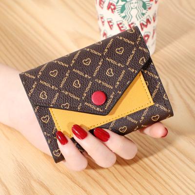 China 2021 new European and American fashion wallet buckle mobile phone bag waterproof female mid length multifunctional bags for sale