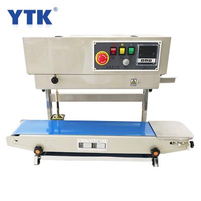 China YTK Food Vertical Heat Machine Food Wrapping Iron Body Automatic Sealing Sealer with FR900LS Conveyor for sale