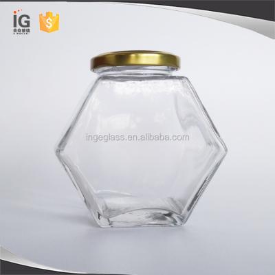 China Sustainable 500 g Hexagonal Glass Honey Jars with Gold Twist Off Lids for sale