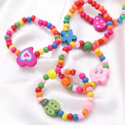 China Fashion CLASSIC Natural Wooden Bead Bracelet Kids Elastic Charms Strap Bracelet 10 Pcs Party Gift For Girls for sale