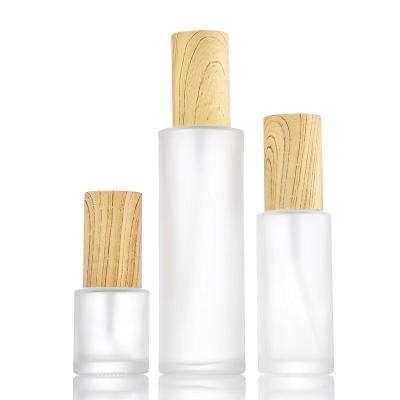 China Personal Care 20ml 30ml 40ml 50ml 80ml 100ml 120ml Flat Shoulder Frosted Travel Lotion Glass Bottle With Bamboo Lid for sale