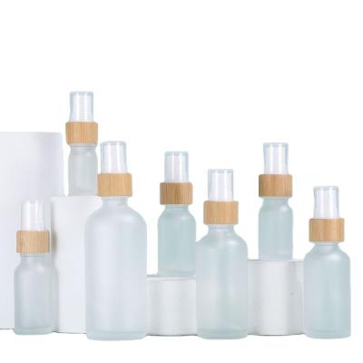 China Personal Care Cosmetic Glass Alcohol Bottles Frosted Glass Spray Bottles 100ml With Bamboo Pump Spray for sale