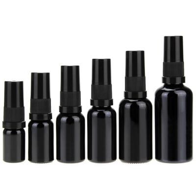 China Personal Care 5ml 15ml 20ml 30ml 50ml 100ml High End Leakproof Matte Black Frosted Cosmetic Glass Bottle Used For Essential Oil for sale