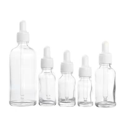 China 30ml 1oz Dropper Bottle Cosmetic Wholesale Transparent Empty Essential Oil Packaging With White Dropper for sale