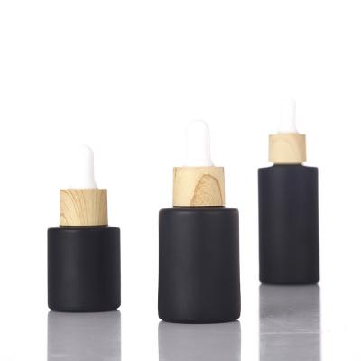 China Personal Care 20ml 30ml 40ml 50ml 60ml 80ml 100ml Black Shoulder Wood Grain Lid Flat Matt Glass Dropper Essential Oil Bottle for sale