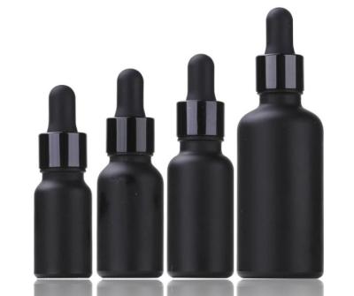 China Personal care frosted black glass bottle 5ml 10ml 15ml 30ml matte black essential oil glass bottles with wooden water transfer dropper for sale