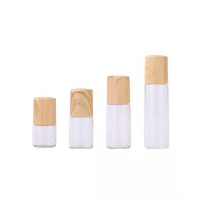 China New Cosmetic Hot Selling Small Mini 2ml Glass Roll On Bottle Bamboo Roller Bottle Cap for sale