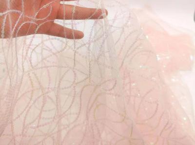 China Shiny piece of gauze fabrics wedding dress embroidery fabrics en venta